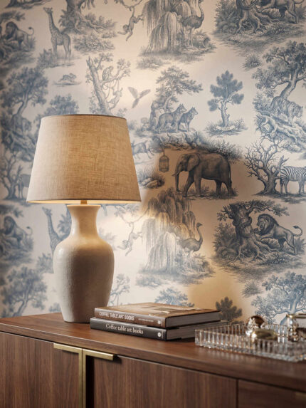 Classic Toile de Jouy wallpaper by Musee featuring intricate engravings of wild animals like giraffes, elephants, lions, and monkeys amidst trees and nature.