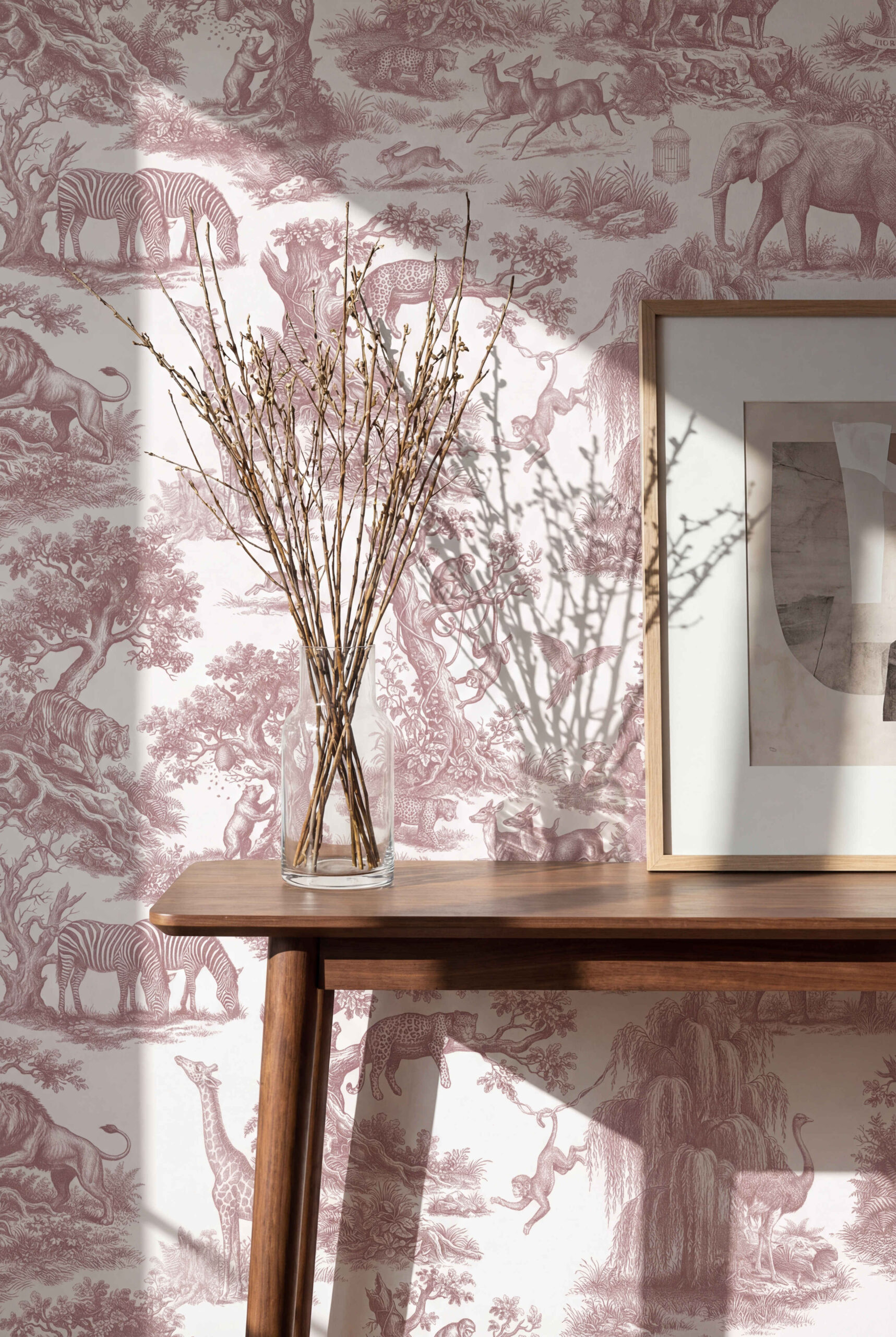 Musee | Wilderness Toile Wallpaper Classic Toile de Jouy wallpaper by Musee featuring intricate engravings of wild animals like giraffes, elephants, lions, and monkeys amidst trees and nature.
