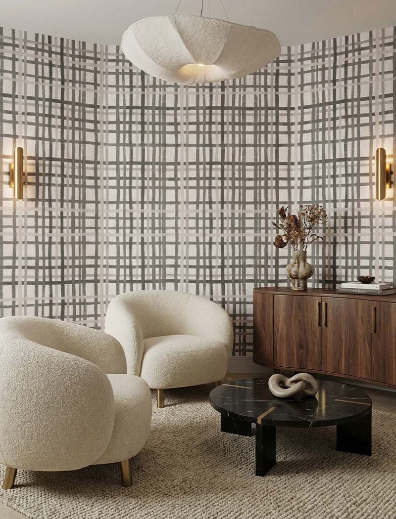 Painterly grey and beige plaid pattern custom wallpaper mural behind modern boucle chairs. "Cozy Check" elegant textured wall design in the UAE.
